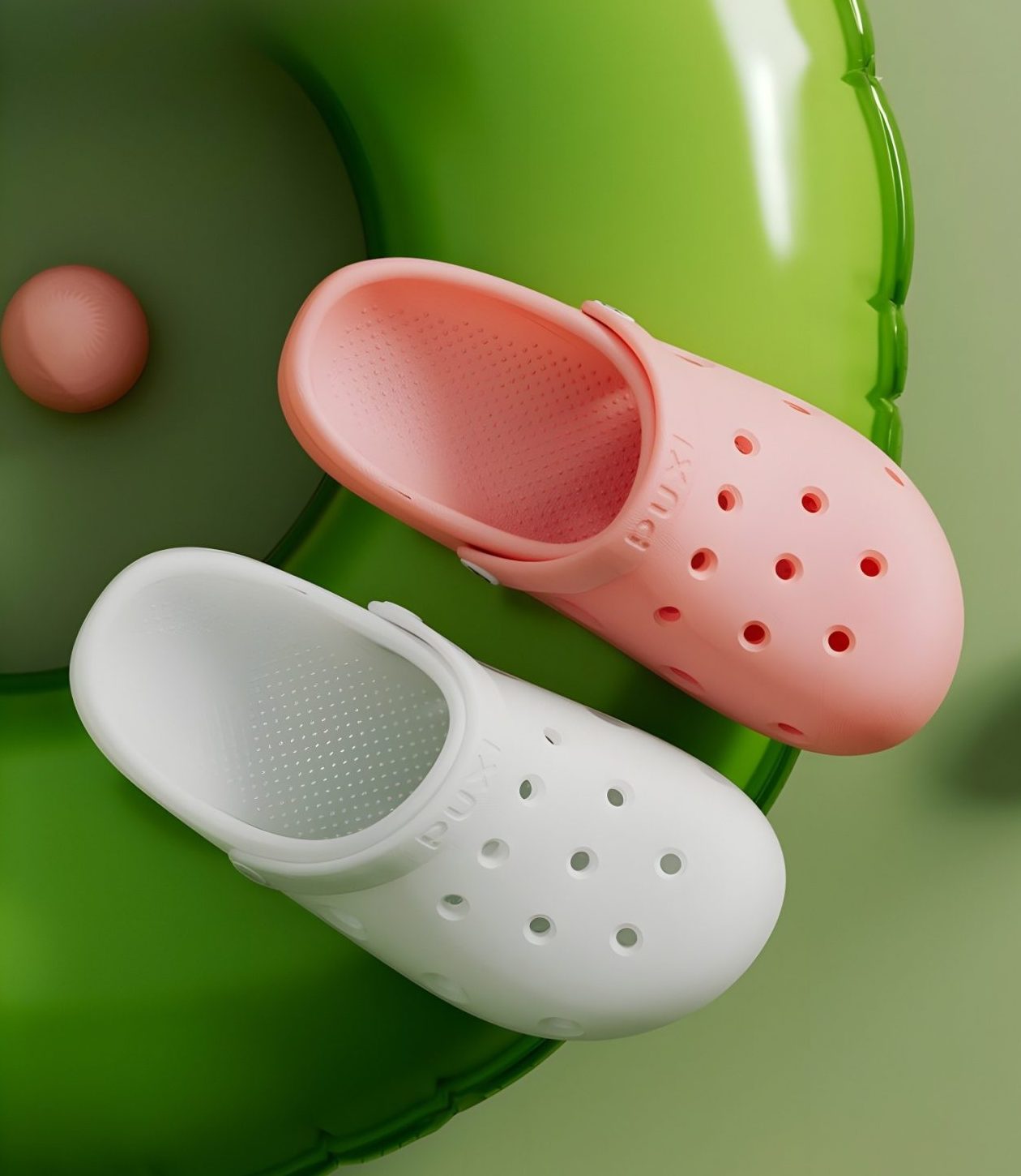 Close-up of pink and white PUXI sandals on a green inflatable ring, showcasing color options and design details