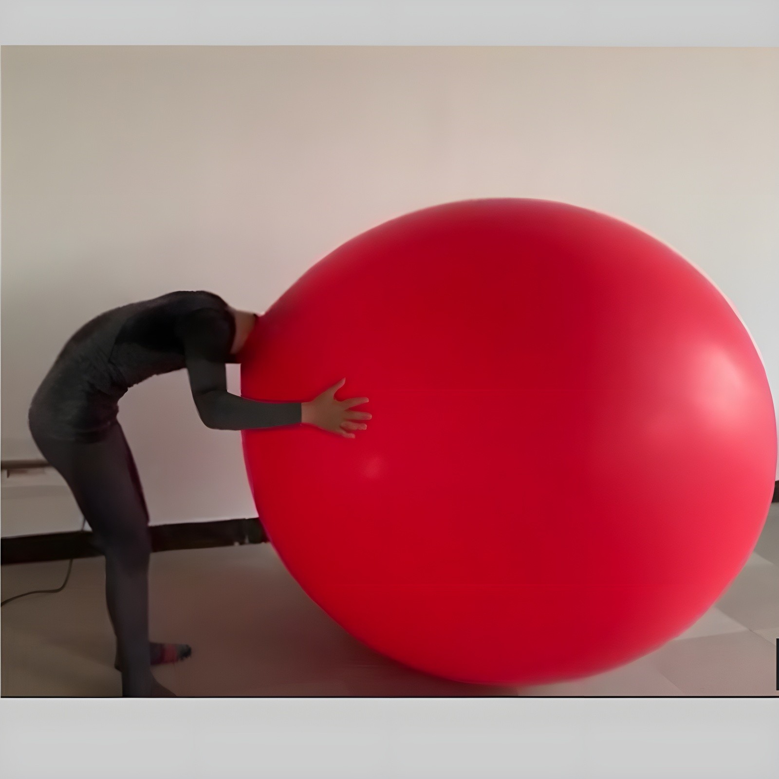 Performer interacting with a giant red balloon
