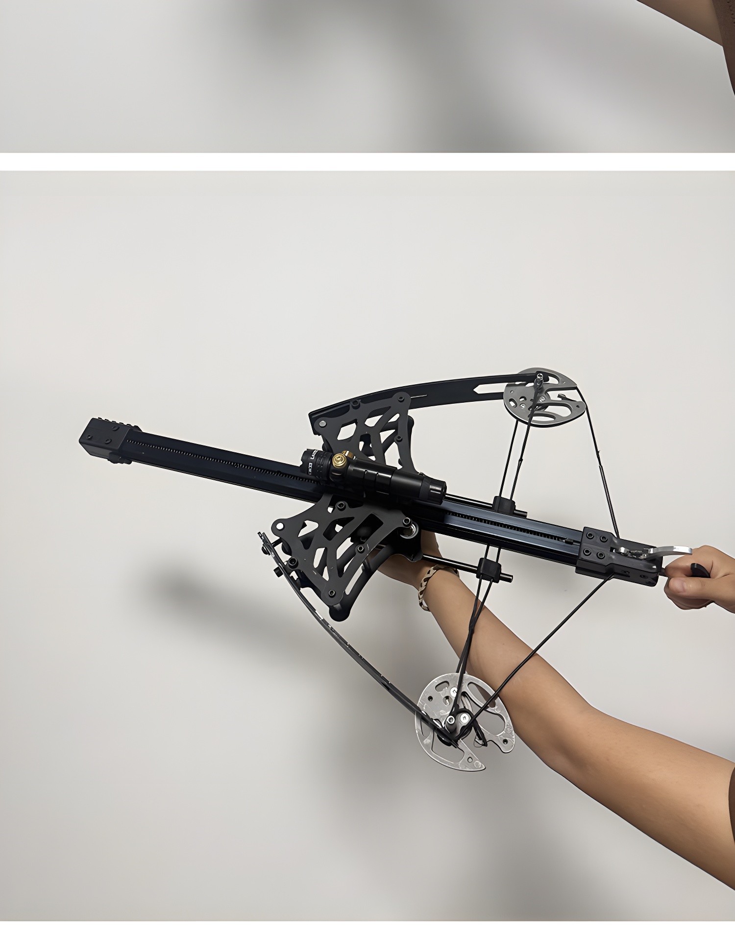 Side view of the composite bow showing the cam system and rail