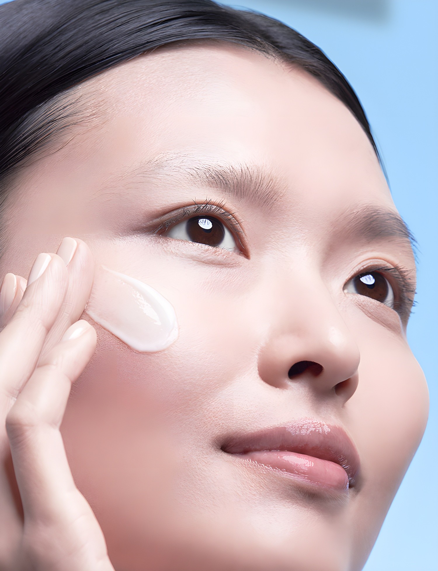 Close-up of applying emulsion to cheek