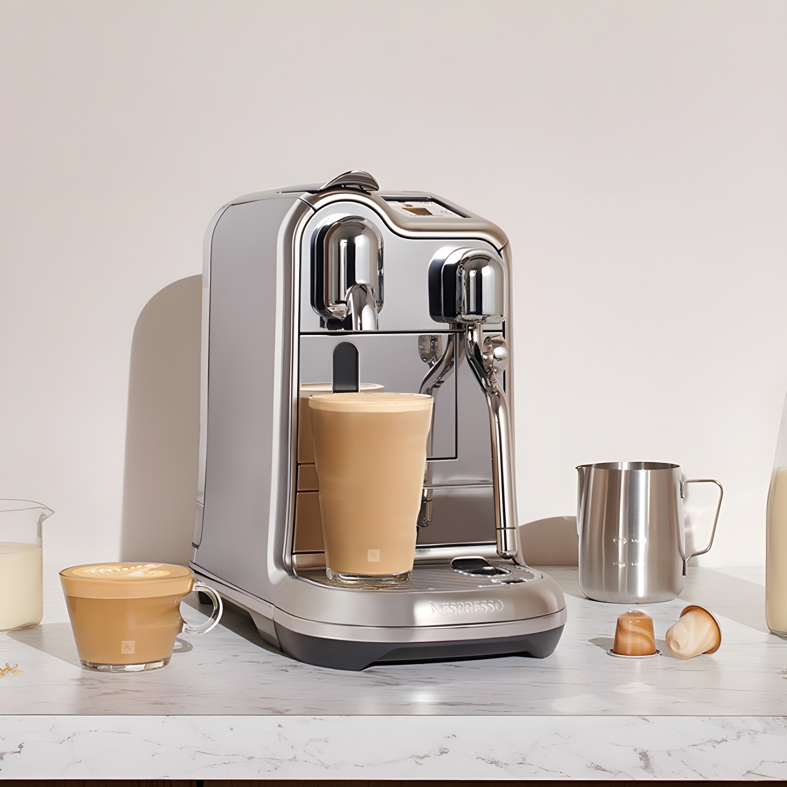 Nespresso Creatista Pro on a marble countertop with freshly brewed drinks and milk pitcher