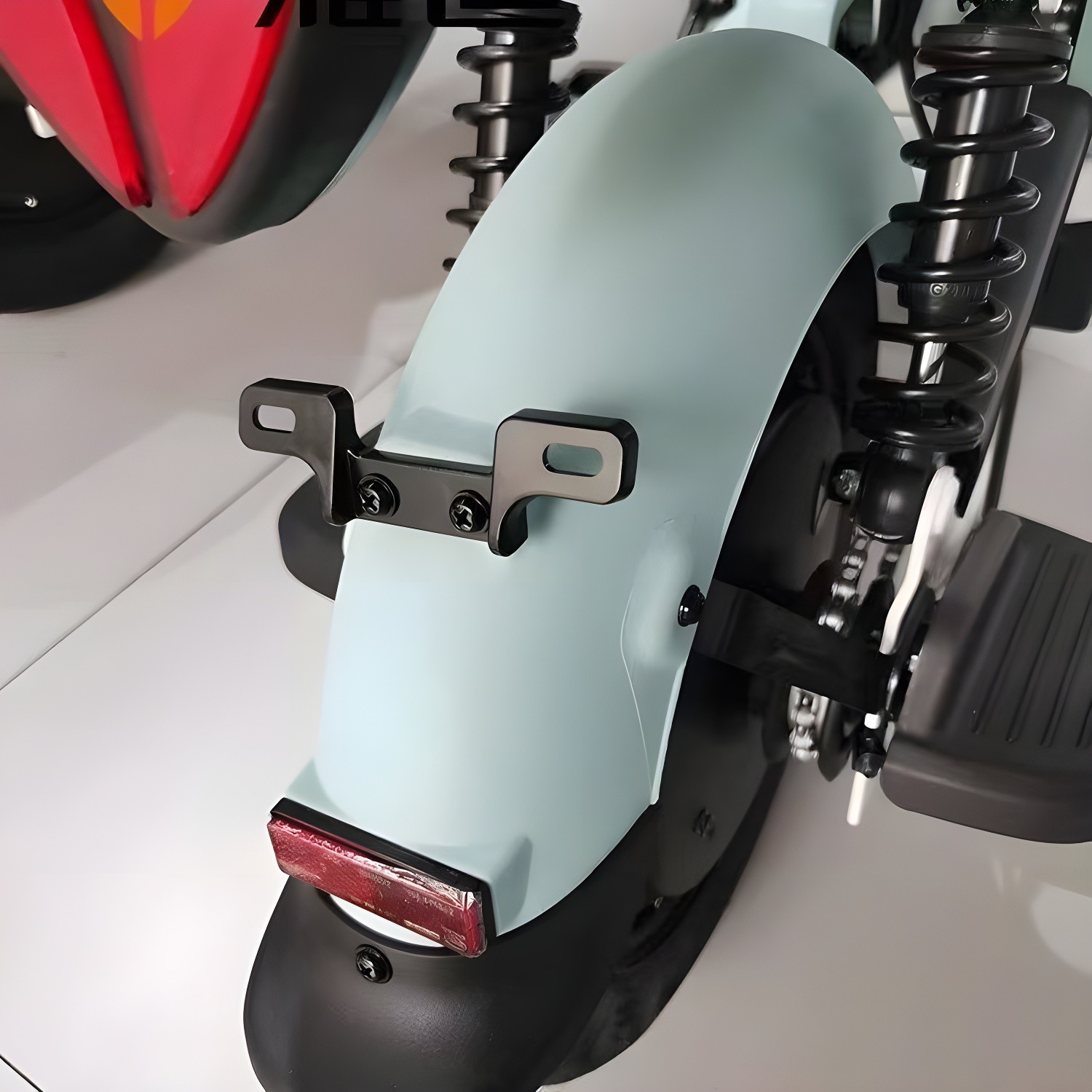 Tailplate bracket installed on light blue scooter