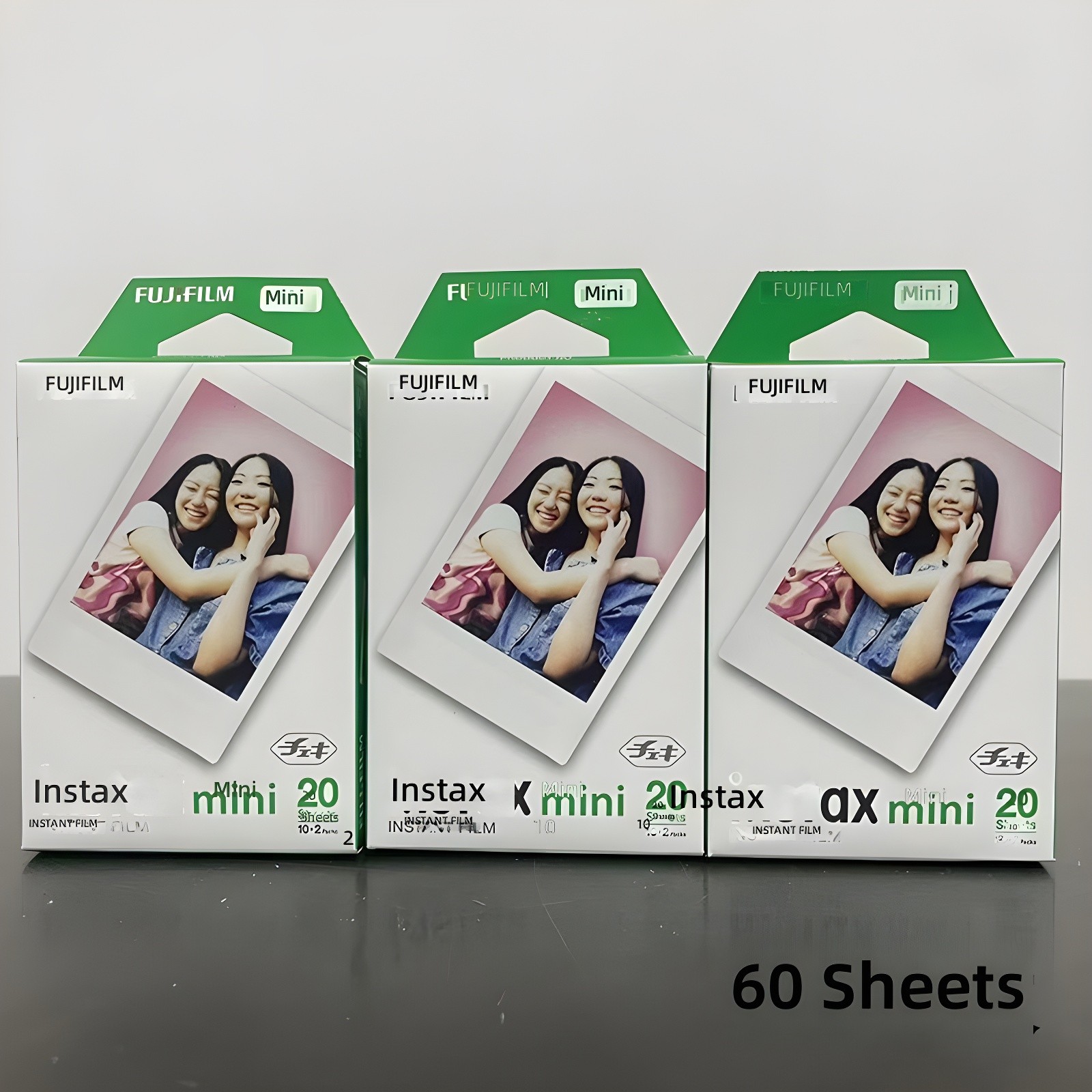 Close-up of three Fujifilm instax mini 20 film packs, emphasizing packaging details and '60 Sheets' annotation