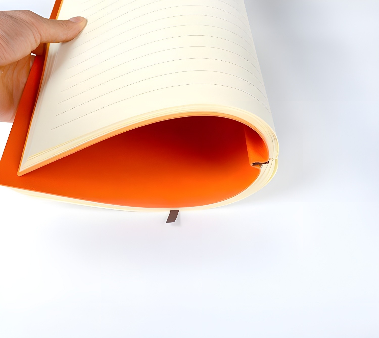 Close-up of an open orange Chronicle notebook showing lined pages, cream-colored paper, and 15mm spacing