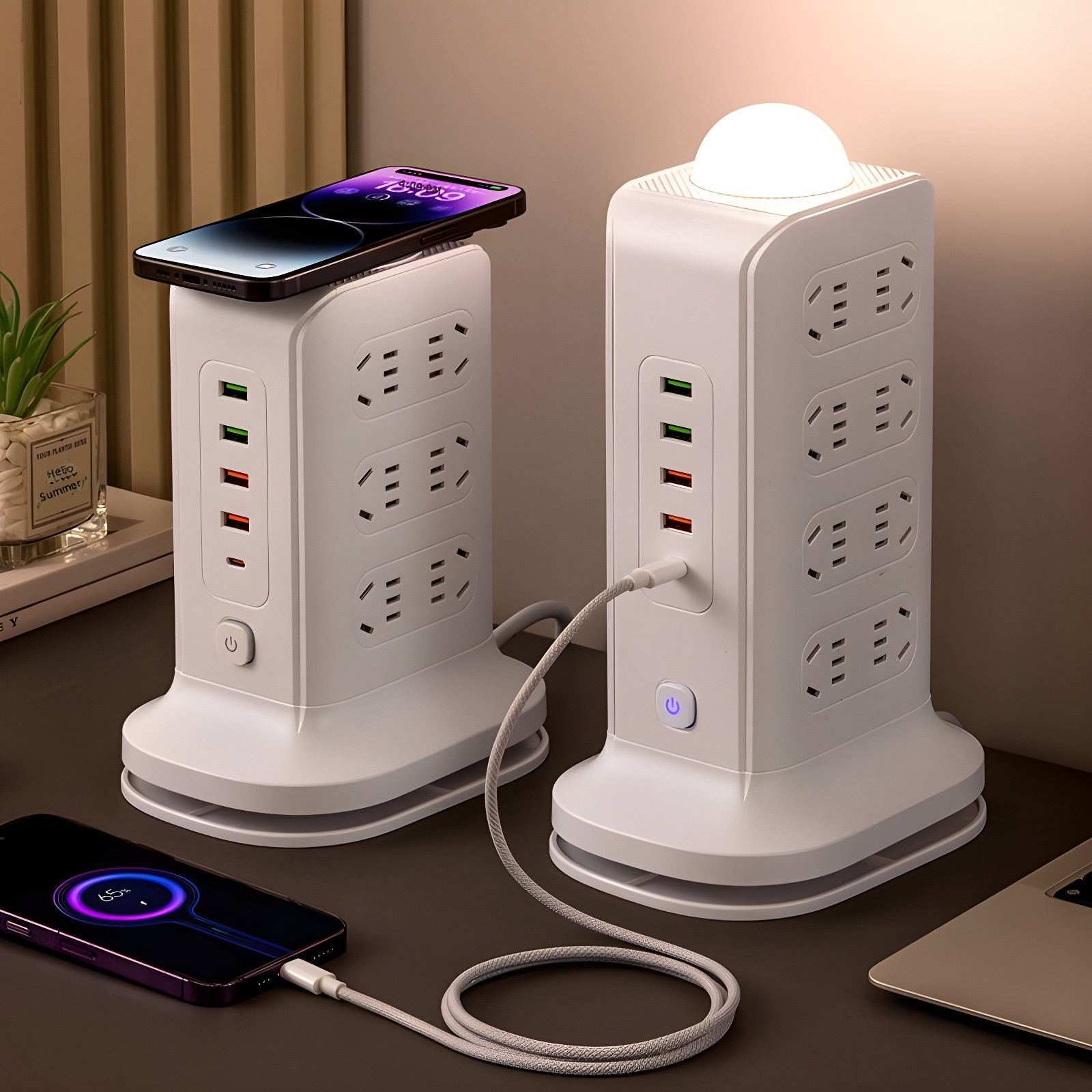 Two smart power towers on a desk with phones, laptop, and plant