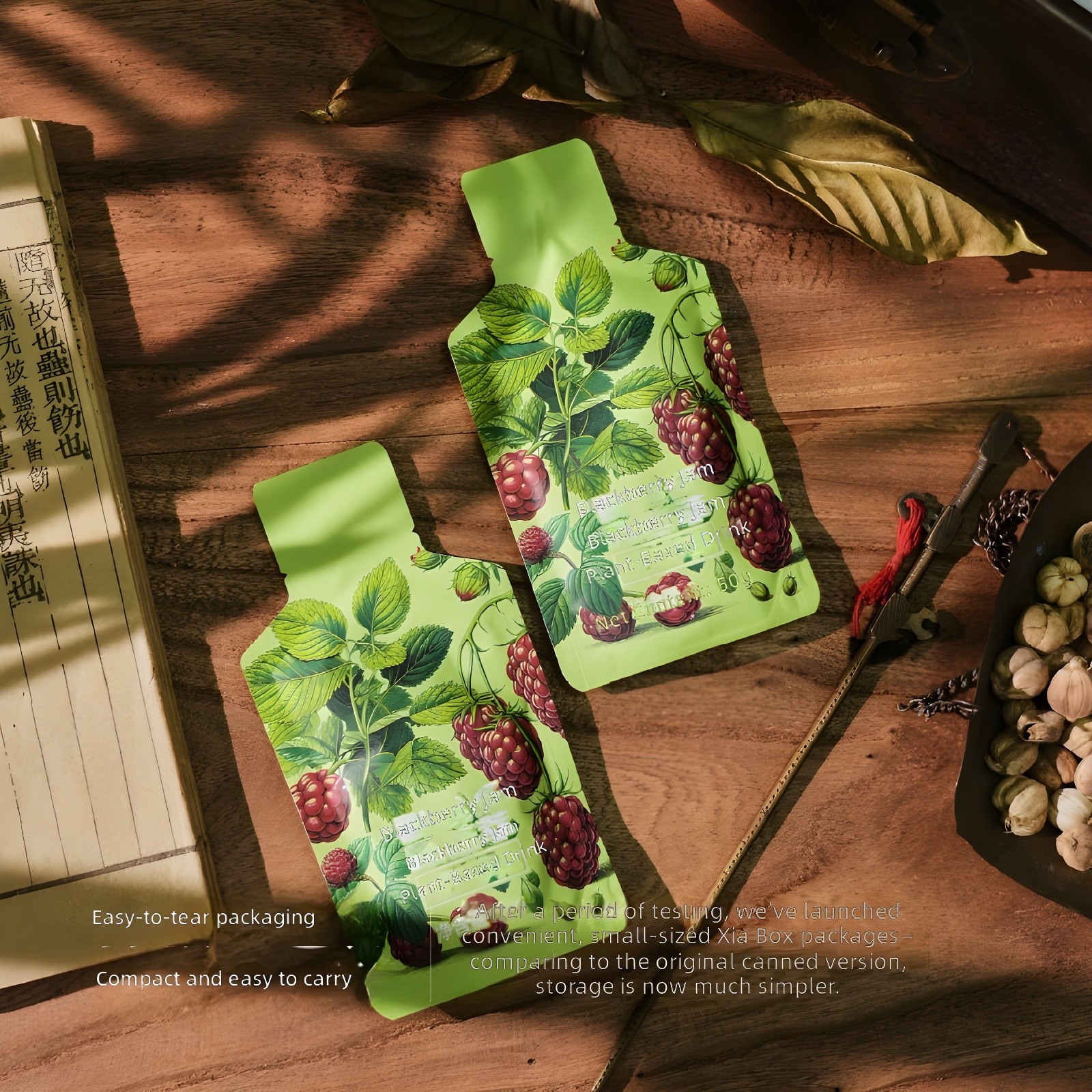 Close-up of two green sachets on wooden surface with dried leaves, antique book, and traditional tools; text highlights 'Easy-to-tear packaging' and 'Compact and easy to carry'