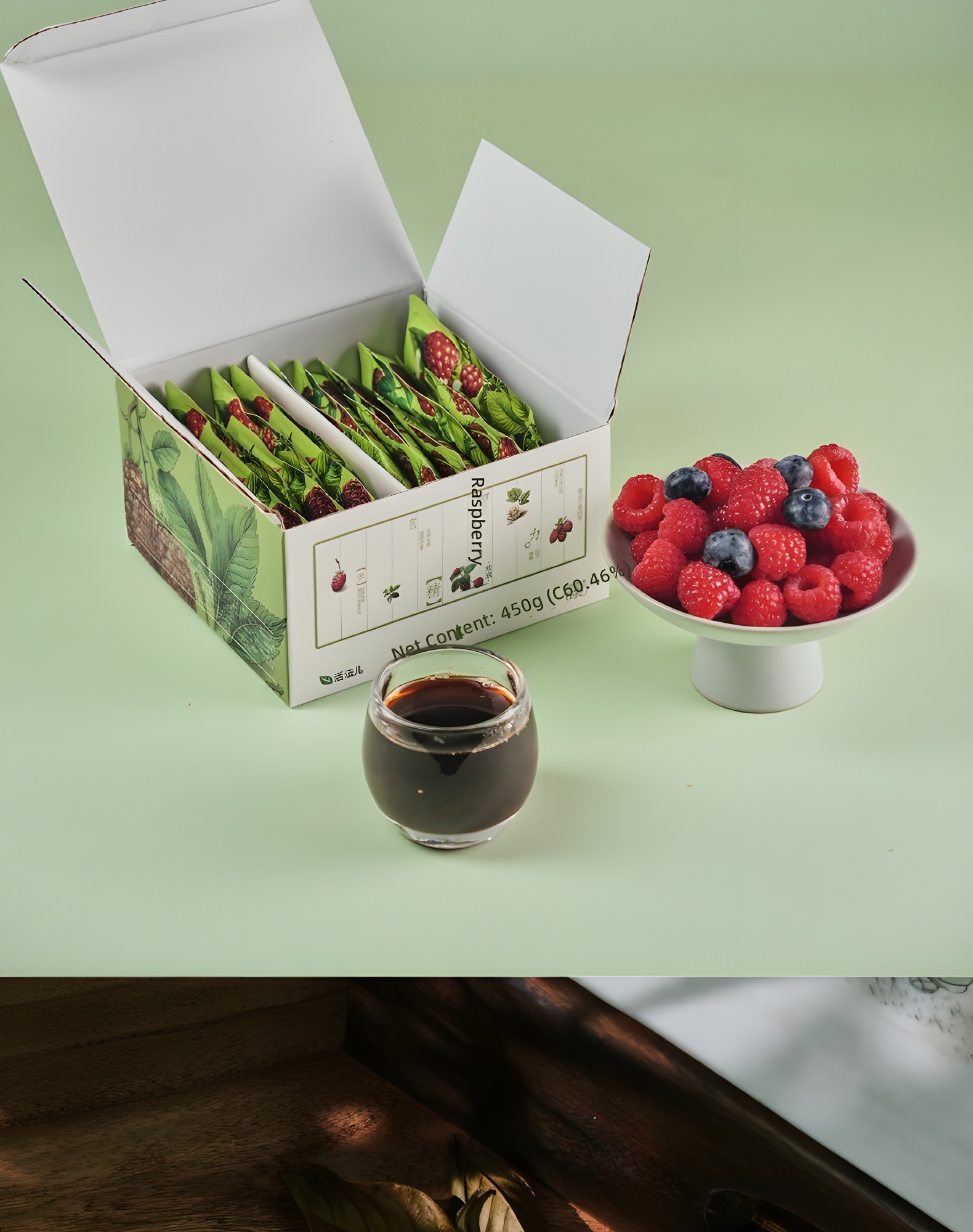 Open box with sachets, glass of juice, and bowl of berries on mint-green background; net content label visible: 'Net Content: 450g (C60.46%)'