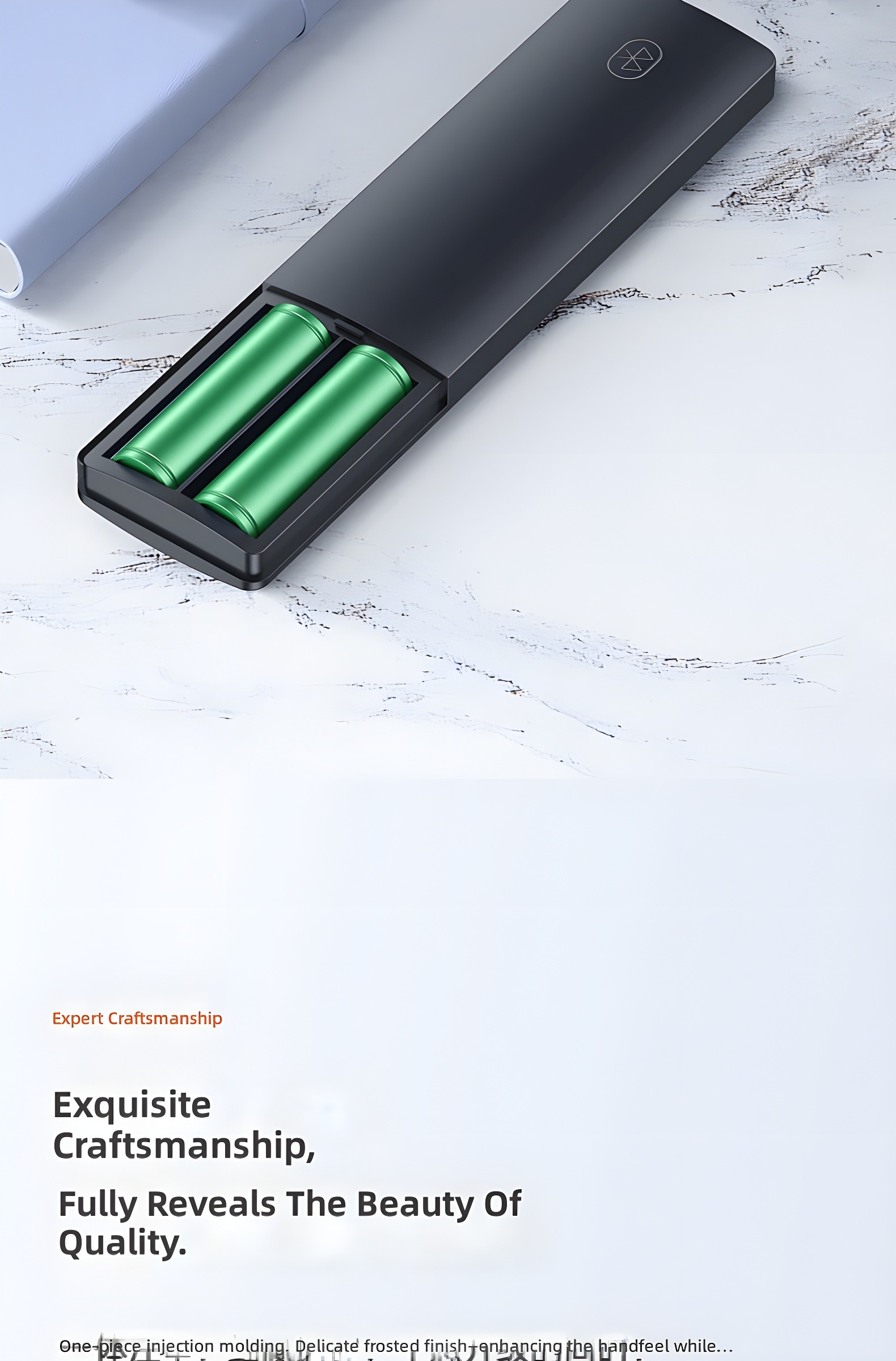 Remote with battery compartment open, revealing two green AAA batteries